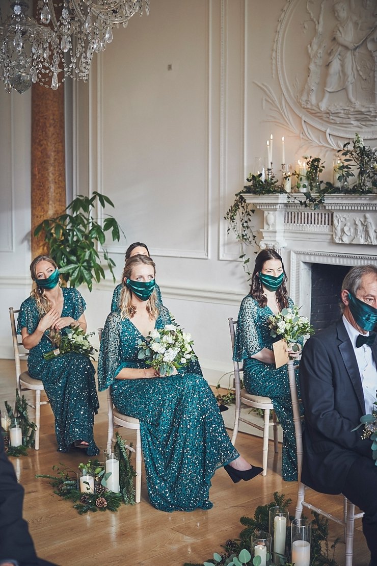 bridesmaids wearing matching green silk cover face masks at small wedding at Rockbeare manor in Devon