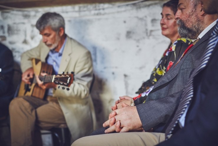 guests holding hands at humanist ceremony at East Soar in Devon