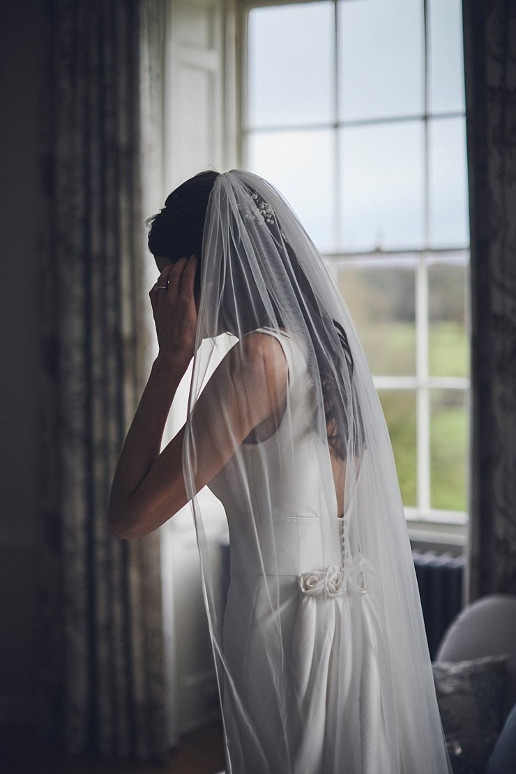 portrait of bride wearing veil at Rockbeare manor Devon
