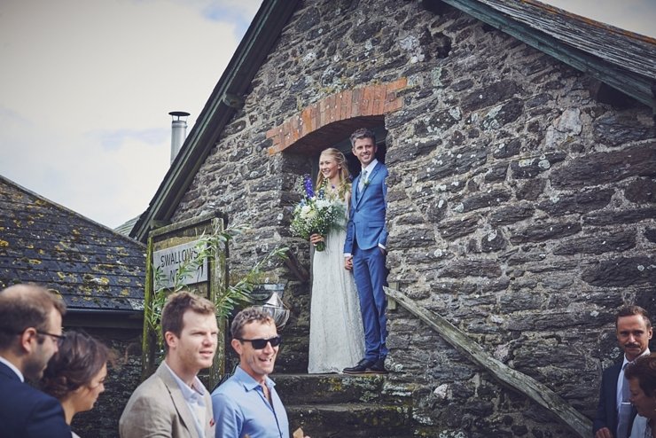 guests holding hands at humanist ceremony at East Soar in Devon